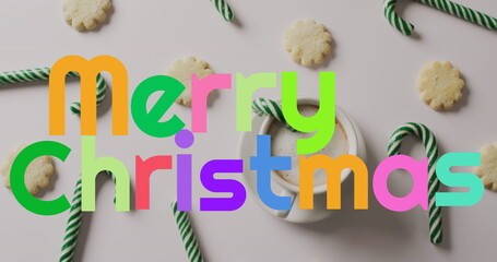 Image of christmas greetings text over christmas candy canes and decorations © vectorfusionart