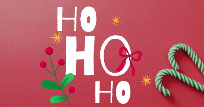 Image of christmas greetings text over christmas candy canes and decorations