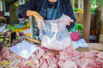 seller, butcher cuts fresh chicken at the market, butcher cuts chicken.