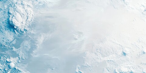 A serene aerial view of icy terrain, showcasing a blend of white snow and blue glacial patterns under soft lighting.