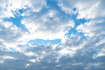 Sky filled with a mix of white and gray clouds. With patches of blue sky visible between them. An...