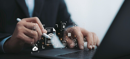 Businessman uses stylus on laptop, interacting with digital documents and wireless technology icons. The image symbolizes modern document management and cloud-based file sharing in digital workspace