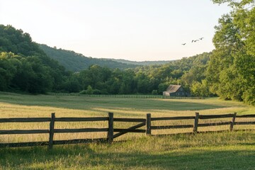 Serene rural landscape with a rustic cabin, green valley, split-rail fence, and birds in flight at sunset.