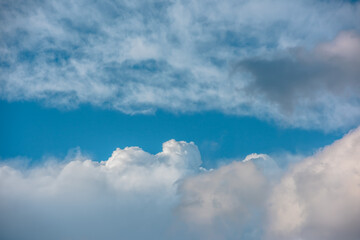 Scenic view to dark gray rainy cloud among light clouds in blue sky. Nature background of dramatic...