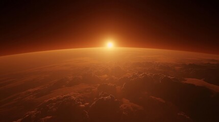 Sunrise over clouds with orange atmospheric glow