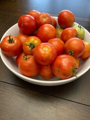 fresh harvested variety of organic tomatoes  in a white porcelain bowl