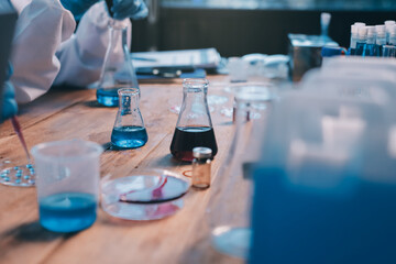 Blood test in the laboratory. Laboratory assistant working with the dispenser. Vacuum tubes with blood.