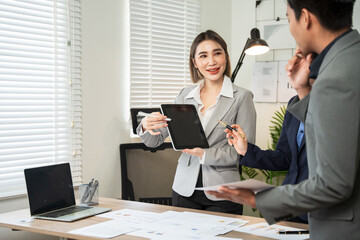 Asian business Talk about new projects, presents at home office.
