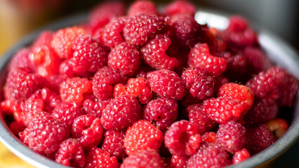 Close-up of raspberries in a bowl. Background with raspberries.