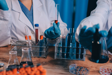 Blood test in the laboratory. Laboratory assistant working with the dispenser. Vacuum tubes with...