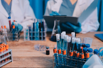 Blood test in the laboratory. Laboratory assistant working with the dispenser. Vacuum tubes with...