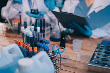 Blood test in the laboratory. Laboratory assistant working with the dispenser. Vacuum tubes with...