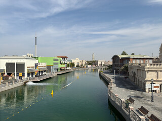 A vibrant snapshot of Riverland Dubai, where charming cobblestone streets, picturesque bridges, and scenic waterways transport you to a world of timeless charm. Lush greenery and European-style.