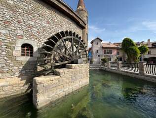 A vibrant snapshot of Riverland Dubai, where charming cobblestone streets, picturesque bridges, and scenic waterways transport you to a world of timeless charm. Lush greenery and European-style.