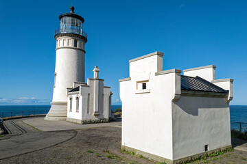 The old oil house and historic North Head Lighthouse at Cape Disappointment State Park, Ilwaco, Washington, USA