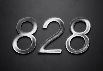 Chrome metal 3D number design of 828 on grey background.