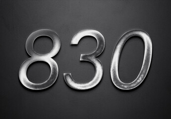 Chrome metal 3D number design of 830 on grey background.