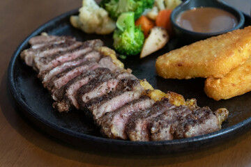 Delicious steak with hash brown, vegetables and sauce.