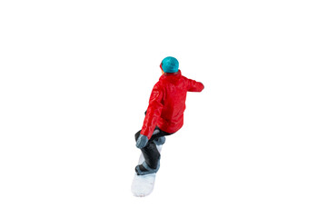 Miniature figurine depicting a snowboarder in mid-motion isolate on white background with clipping path