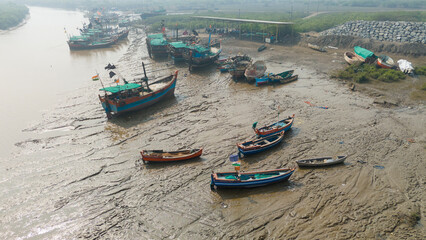 Aerial shot of fishing boat in dirty muddy water.
