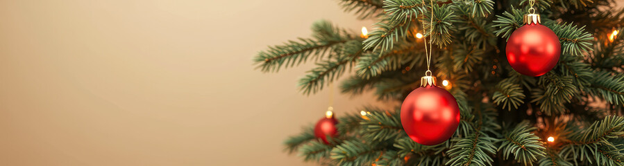 Fototapeta premium three red ornaments adorn a decorated evergreen tree