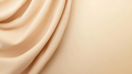 Draped beige fabric on a light background