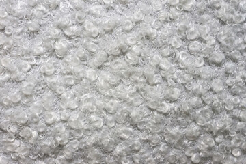 Close up view of white astrakhan karakul. Lamb fur texture. Background for designers.