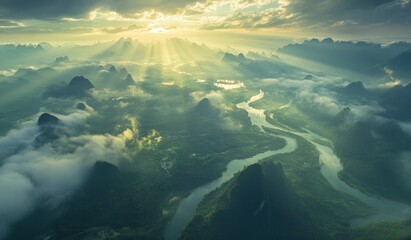 A breathtaking aerial view of the picturesque Li River in Yangshuo, Guilin, China. The mountains and rivers are bathed in sunlight, with rays piercing through the clouds, creating an enchanting scene