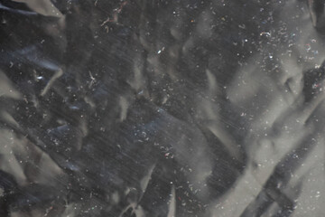 full frame abstract background of crumpled black plastic film bag