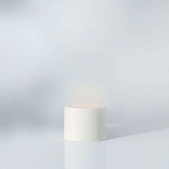 white cylindrical pedestal with soft inner light
