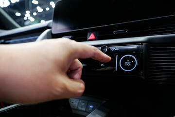 Driver pushing a vehicle engine start button. pressing the electric car engine start stop button
