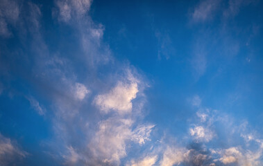 clouds at sunset. blue sky. fluffy cirrus clouds.