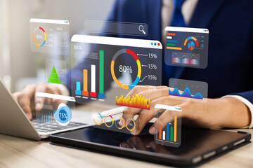 Analyst utilizing technology and dashboard with charts data science and Big Data technology for...