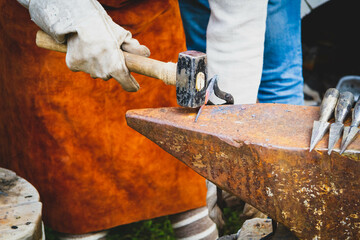 A blacksmith forges iron. Blacksmith's workshop. Blacksmith's anvil and hammer..