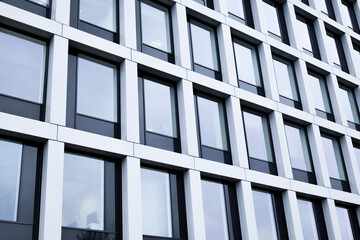 Modern glass building reflecting the sky in an urban area
