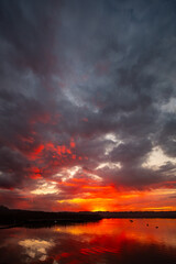 A Dramatic Sunset Over Calm Water Featuring Gorgeous Reflections in the Twilight Sky