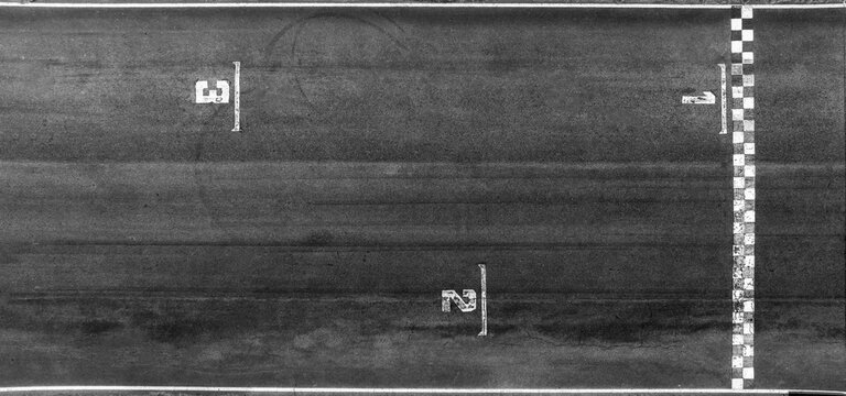 Aerial view race grid start, Start and finish line race track background top view, Start and finish of track racing asphalt road.