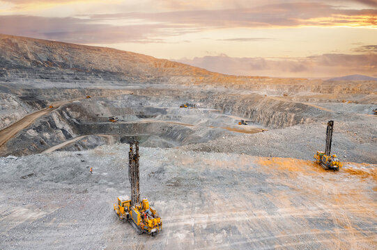 Drilling machine borer installing cast explosives blasting. Banner industry Open coal mine