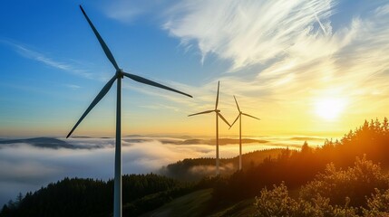 Climate change green energy adaptation concept. Wind turbines at sunset above a foggy landscape.