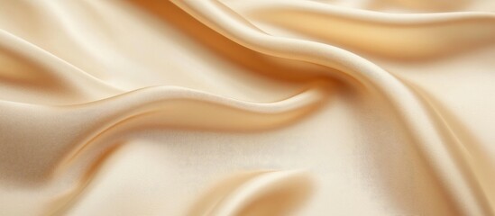 Obraz premium Elegant beige satin fabric background with a soft sheen perfect for product showcasing and sophisticated interior design applications