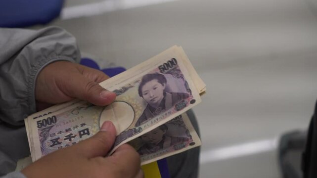 Counting JPY money Japanese Yen banknote in Business people hands for paying shopping goods services, Cash Tax, salary or payment saving cash for economy