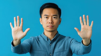 Man expressing refusal with raised hands against a blue background showing themes of rights, restrictions, and personal boundaries.