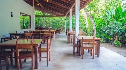 Inviting Rustic Dining Area Surrounded by Lush Greenery in Tropical Setting