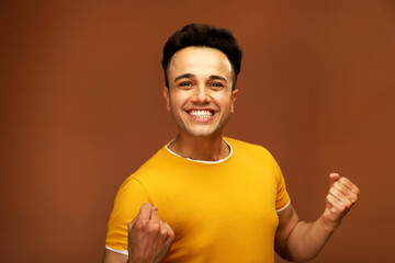 Asian male model screaming while clutching his fists