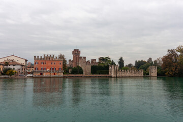 Fototapeta premium A scenic view of Lazise from a boat, highlighting the medieval walls and the town's architecture