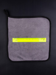 Close-up gray fleece cloth from dirt and dust for cleaning house and car on black background