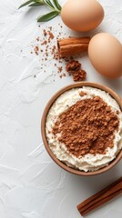 A bowl of whipped cream with cinnamon and an egg