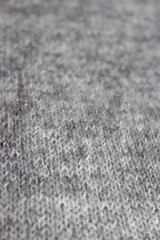 Grey melange knitting background. Mix of grey wool and white cashmere. Knitting pattern background. Knit stitch pattern. Knitting lifestyle. Cozy hobby. Warm knitwear. Craft product concept.