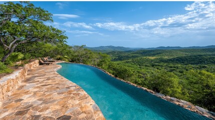 Fototapeta premium A large swimming pool surrounded by trees and mountains