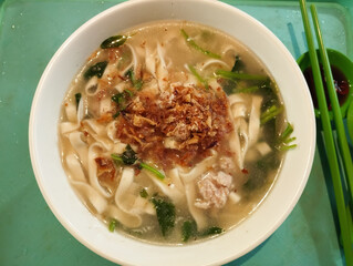 chinese ban mian noodle soup in white bowl